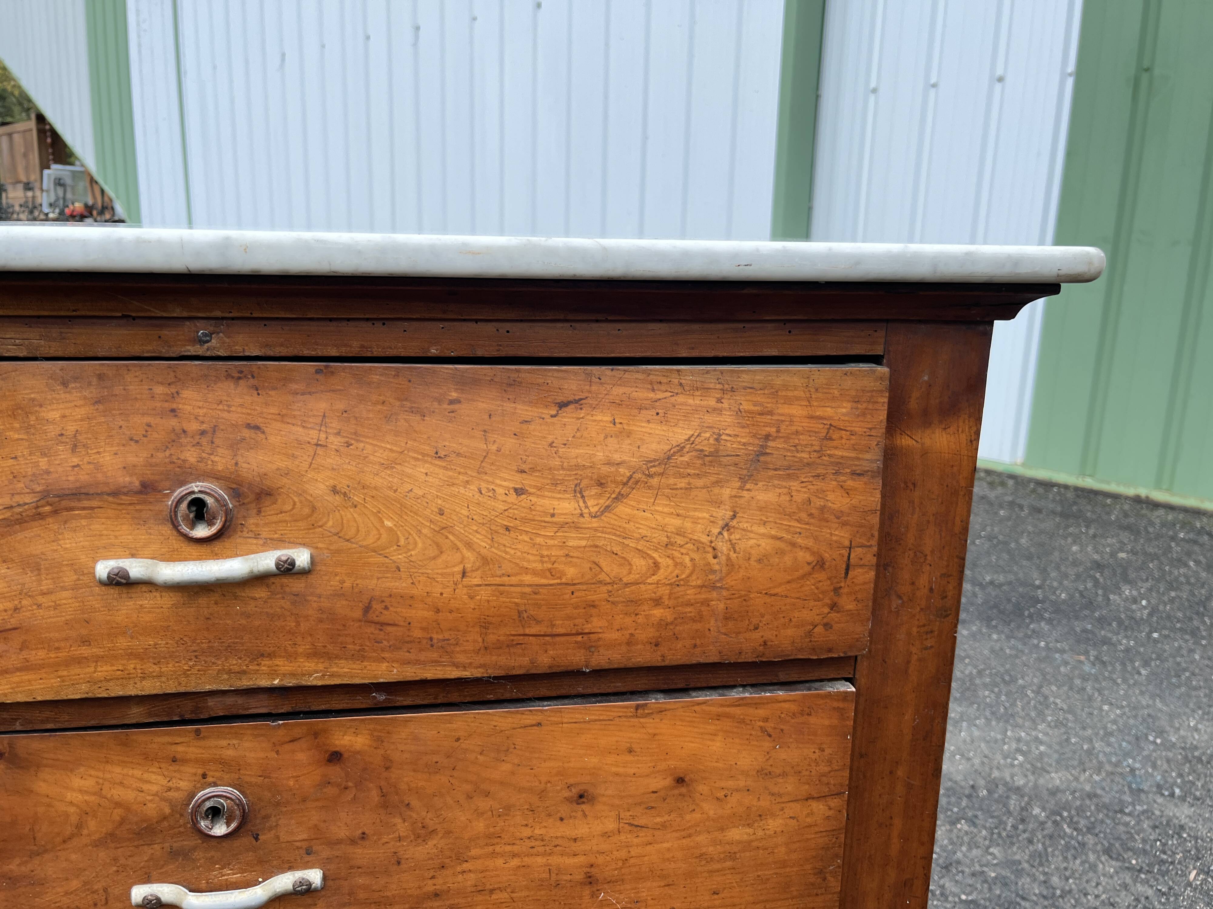 Antique 19th-century wooden chest of drawers with a marble top