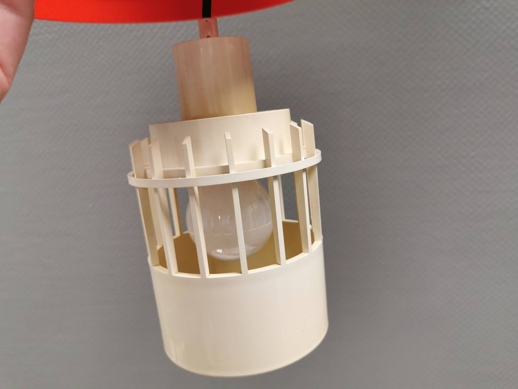 An orange pendant lamp made from hard-pressed ABS plastic. Denmark 1970s