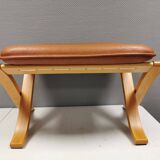 Folding Stool, in light beech wood with cognac colored leather cushion.