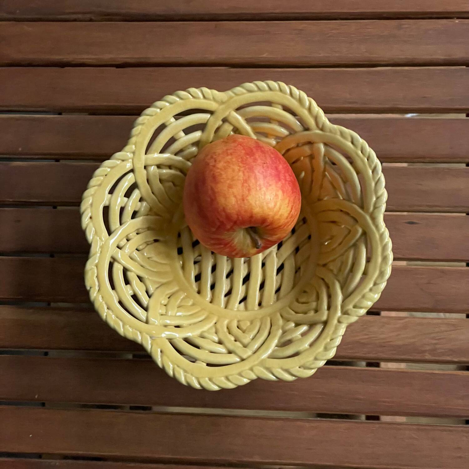 Yellow openwork woven earthenware basket