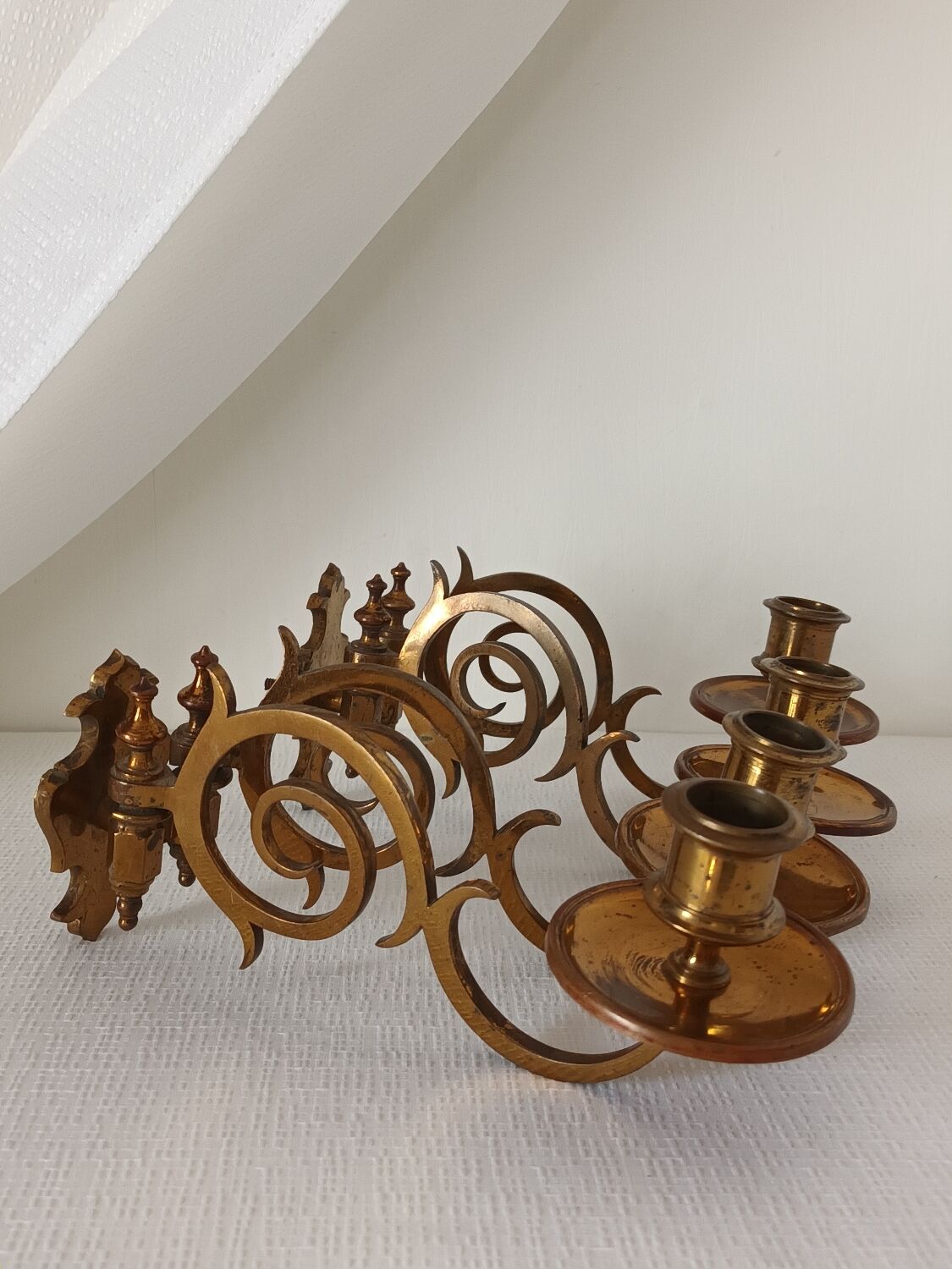 Pair of antique wall-mounted brass candle holders