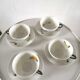 4 cups and cups in fine Limoges porcelain signed LC 60s