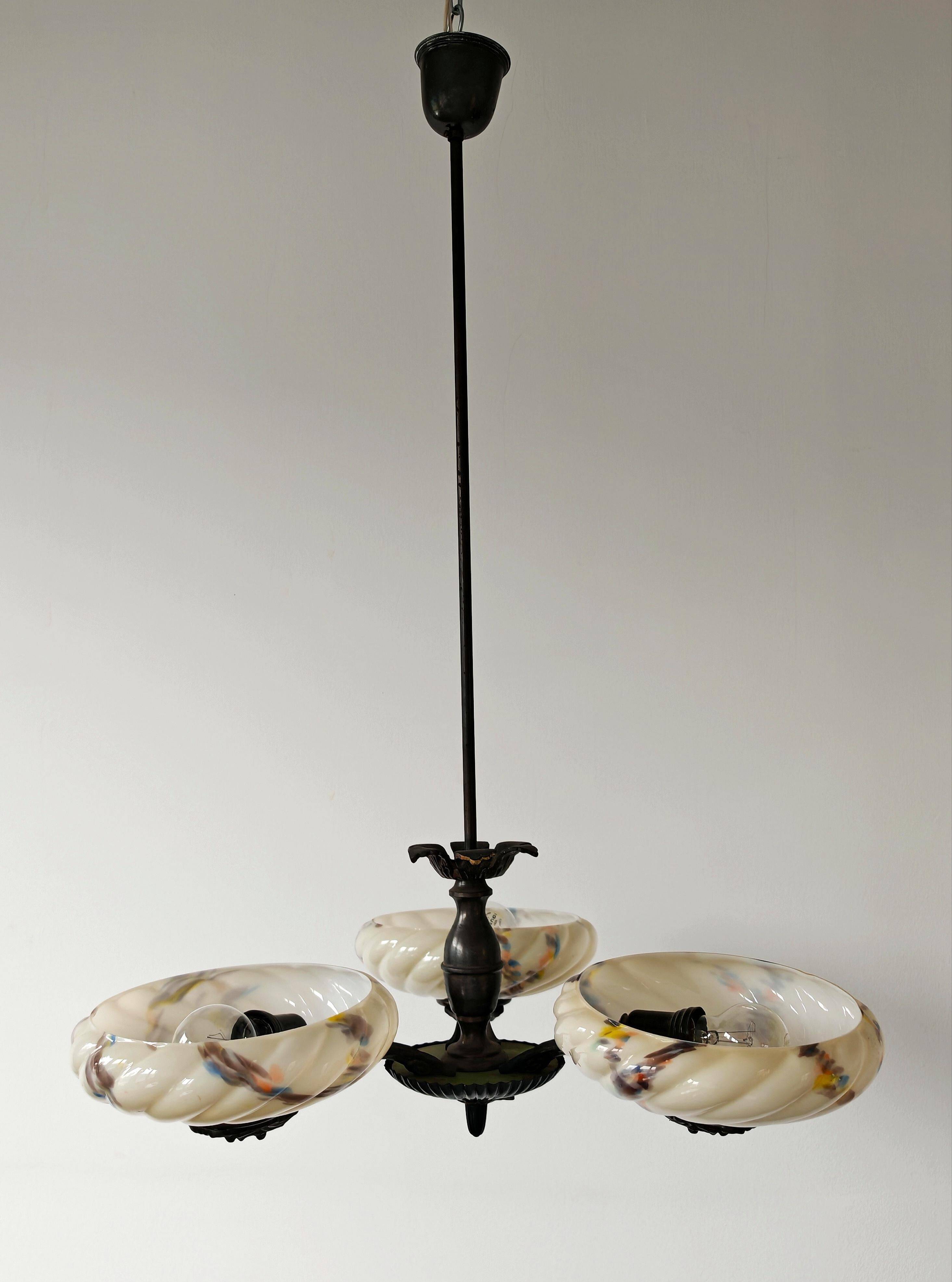 Art Deco bronze three-arm chandelier with marbled glass shades.