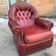 Burgundy leather club chair from the 1950s, with tufted back and studs.
