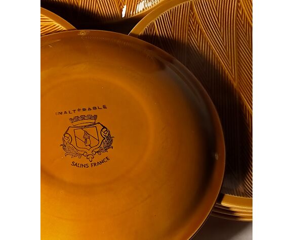 Ten plates in Salins slip with braided patterns 50s