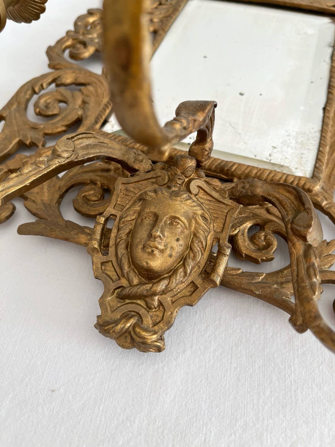 Bevelled mirror wall sconce in gilded bronze with 3 candle holders.