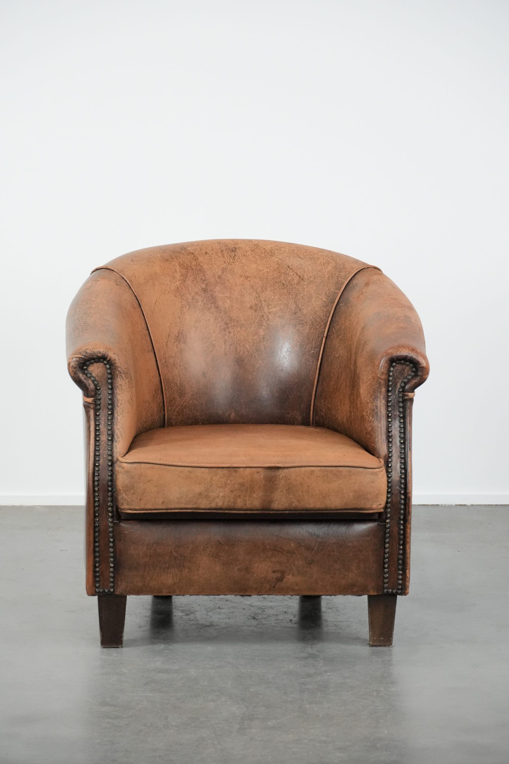 Vintage sheepskin club armchair with character and a beautiful patina