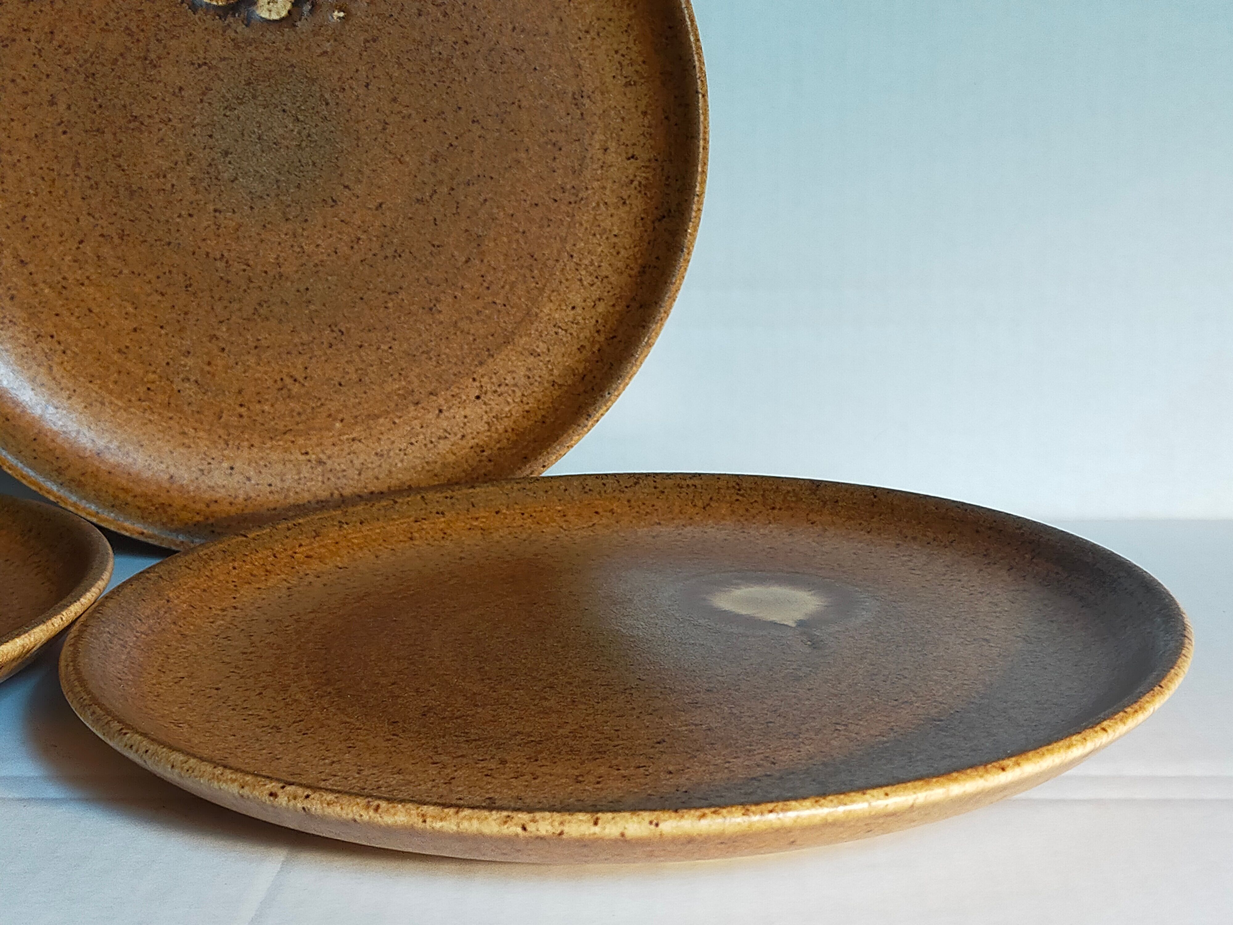 Four vintage glazed stoneware potter's plates