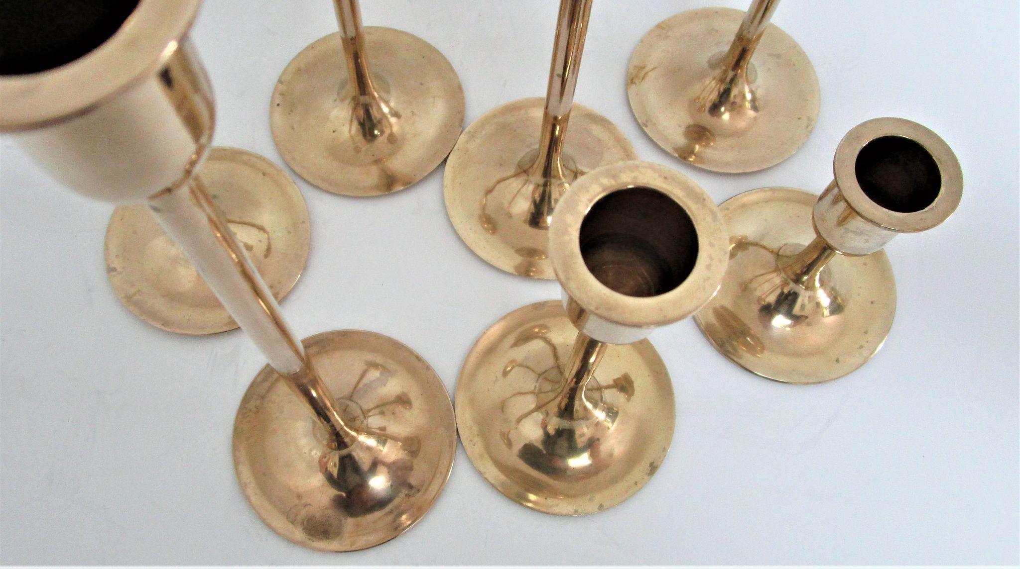 Series of seven candle holders solid brass