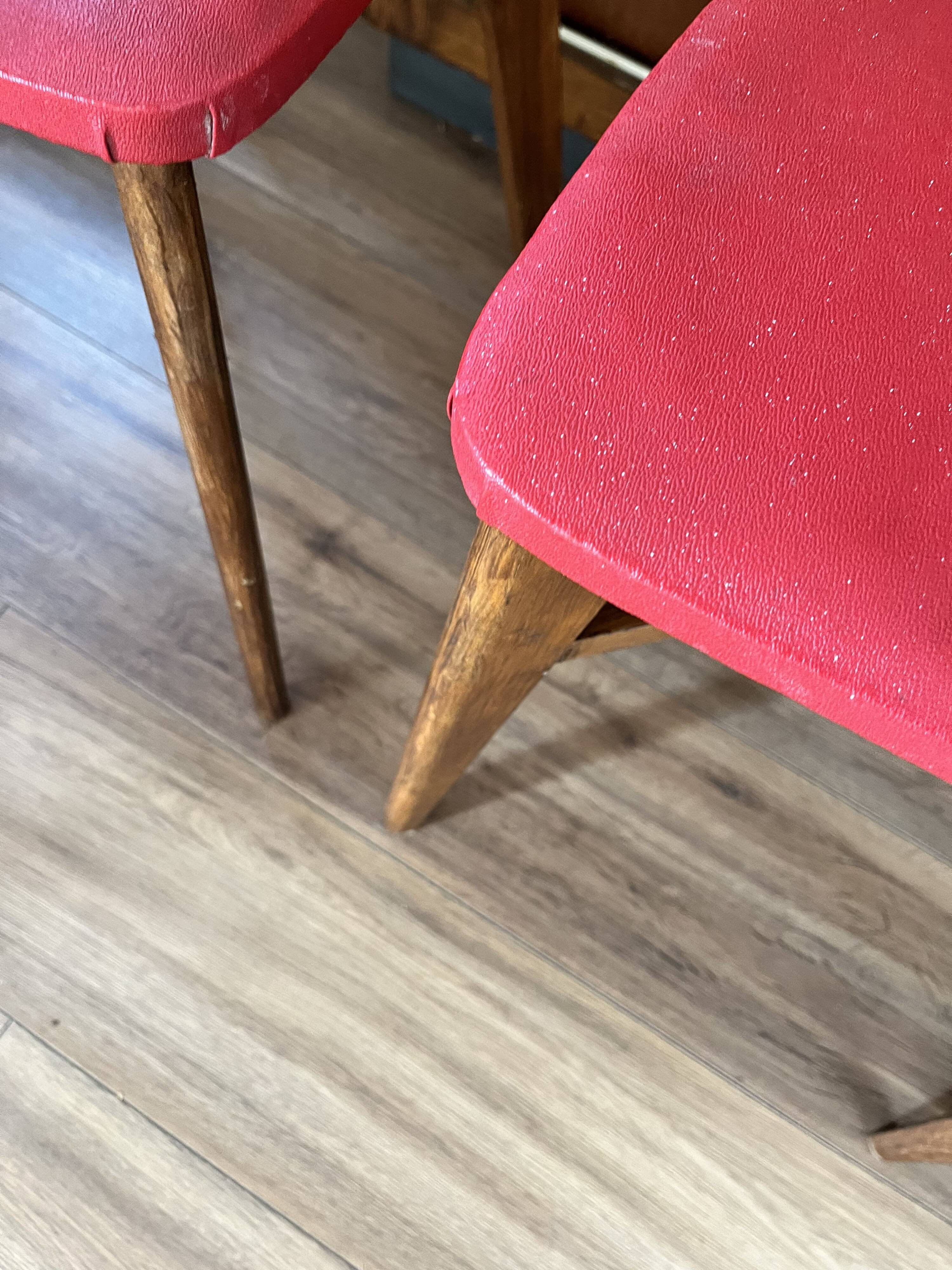 Set of 4 wooden chairs with red vinyl.