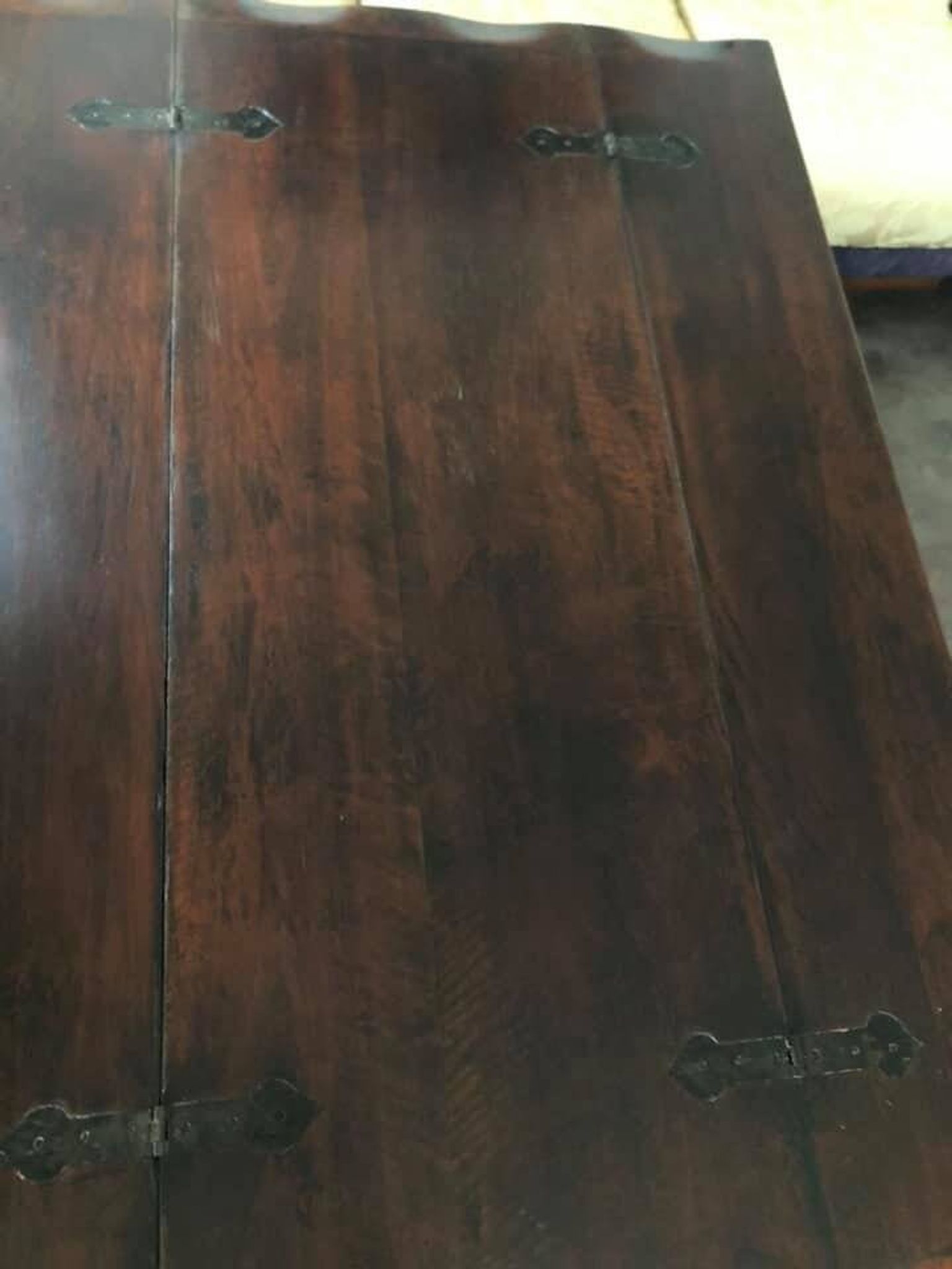 19th-century brown walnut dining table with sculpted trestle legs.