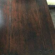 19th-century brown walnut dining table with sculpted trestle legs.