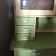 Vintage wooden kitchen cupboard painted green and beige, with glass doors - 1930s