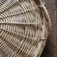 Large round wicker tray with two handles, vintage weaving.