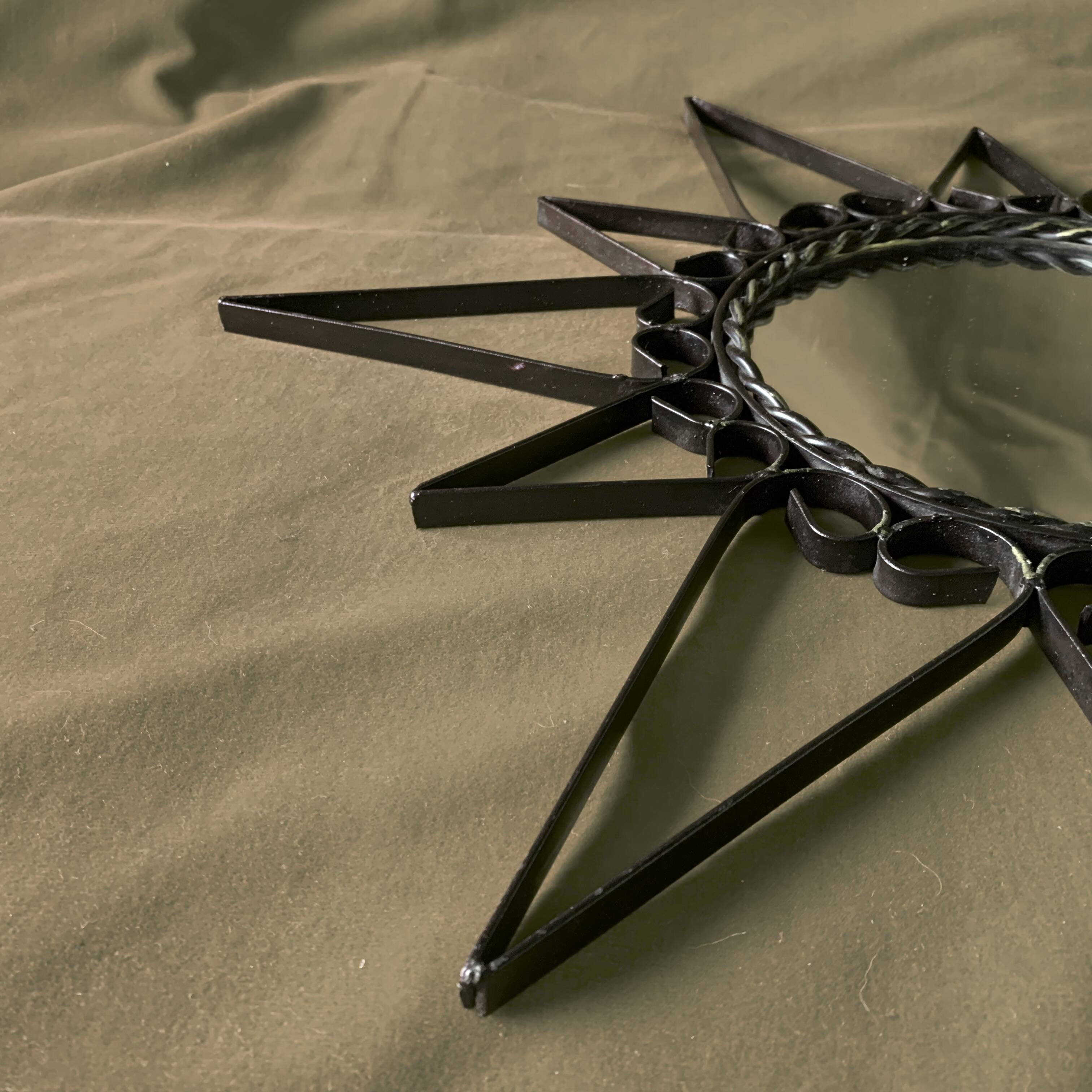 Old wrought metal sun mirror