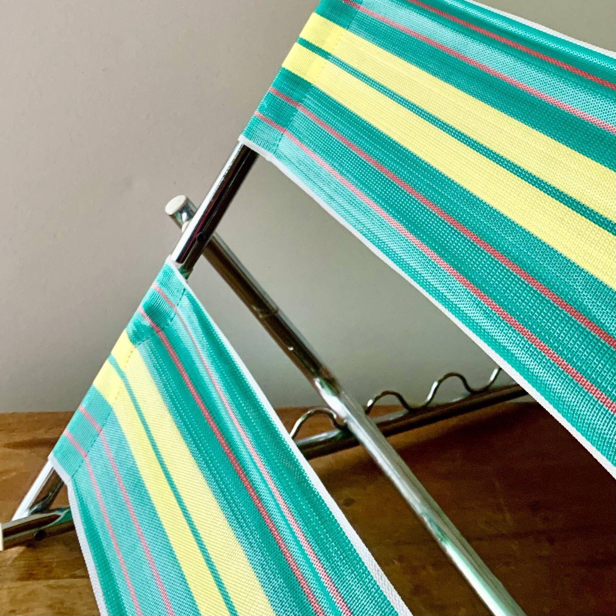 Vintage folding beach chair in chrome metal and woven plastic