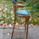 Bar stool in green leather and curved wood
