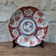 Antique Imari deep plate with red and blue floral decoration, 21.5cm.