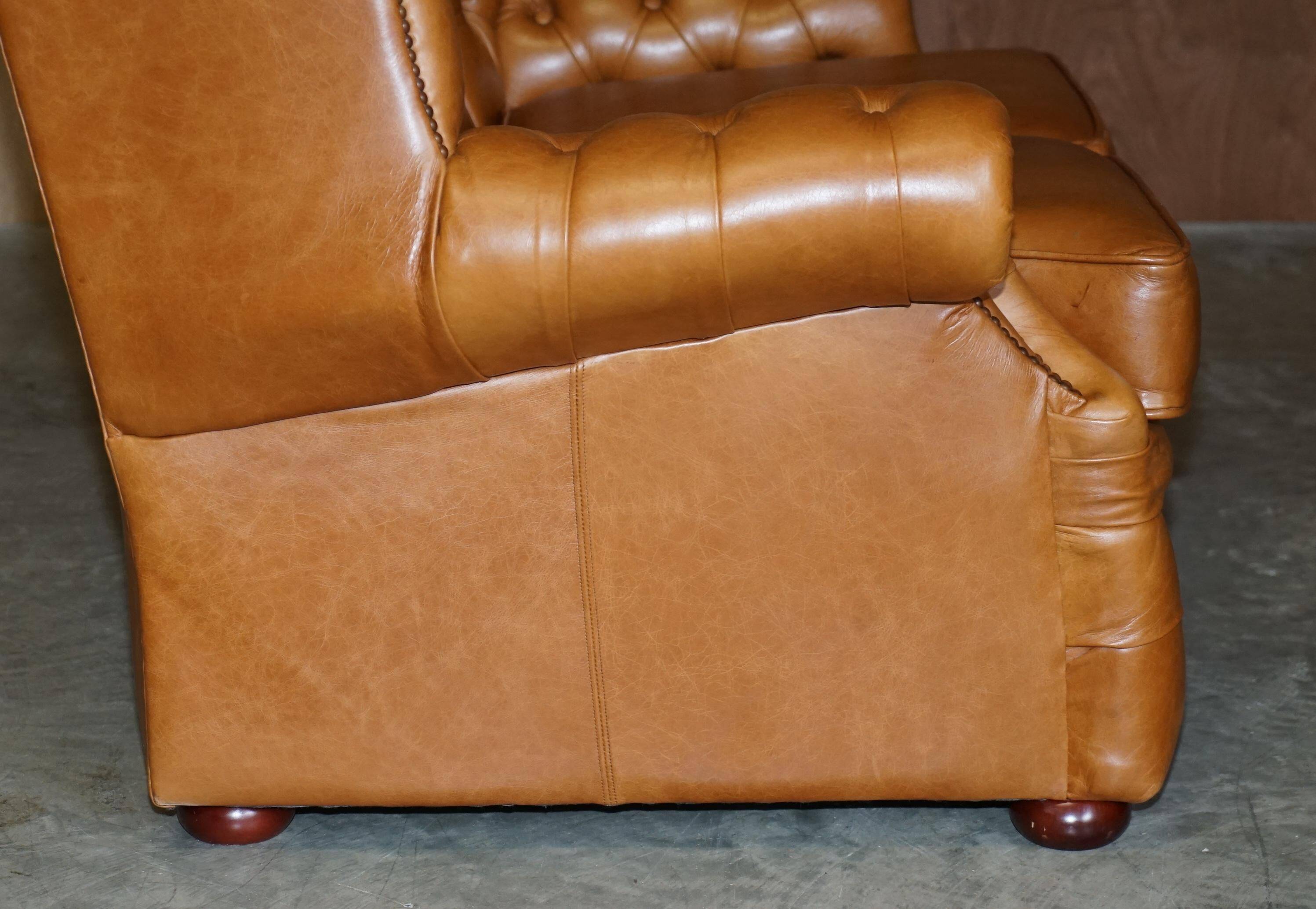 Small Chesterfield leather sofa with a high back.