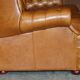 Small Chesterfield leather sofa with a high back.