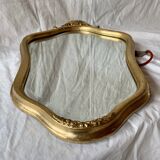 Ancien miroir mural biseauté en bois massif doré