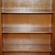 Corner library made of flamed hardwood, in 3 parts.