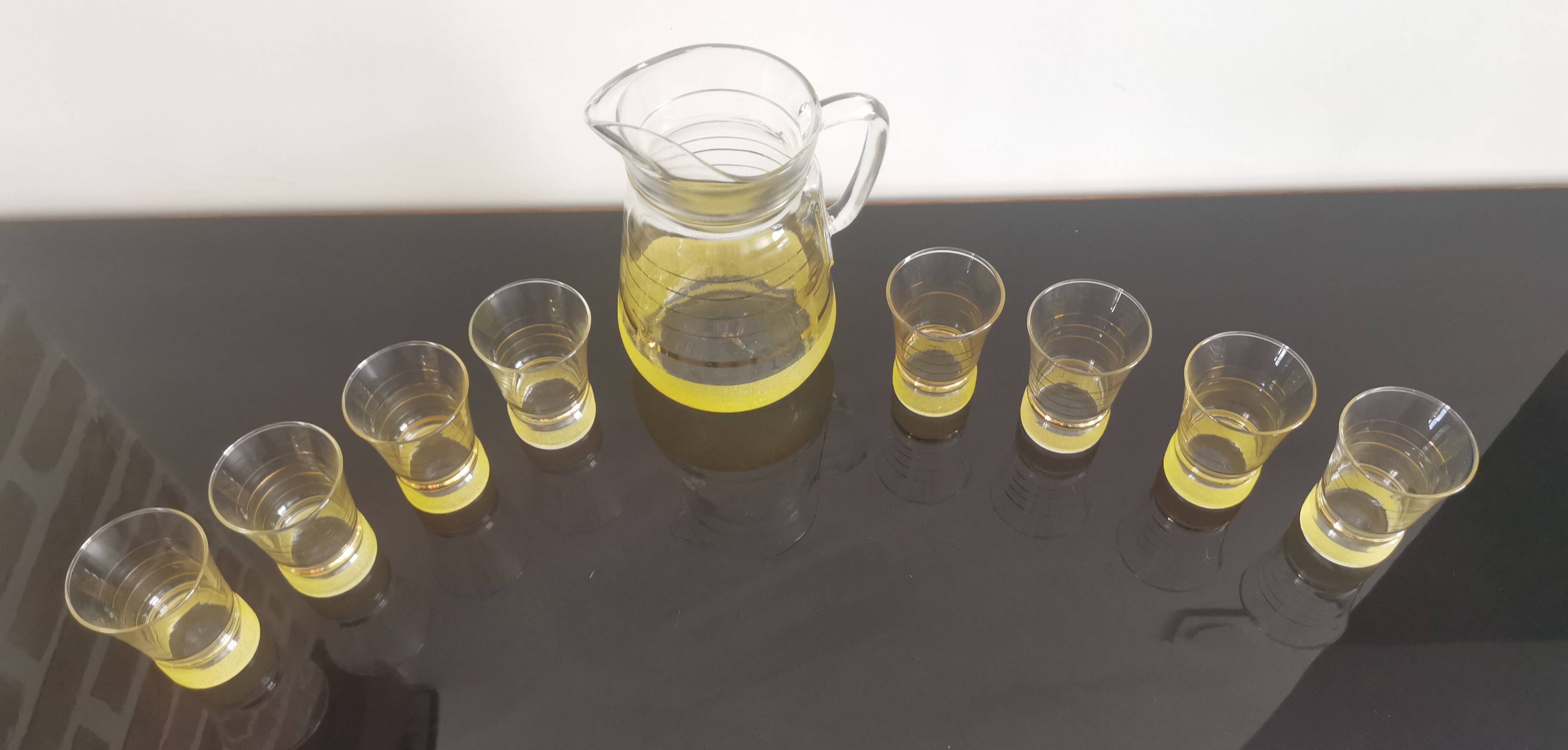 Old pitcher with its 8 yellow granite glasses with gold edging vintage 50's