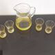 Old pitcher with its 8 yellow granite glasses with gold edging vintage 50's