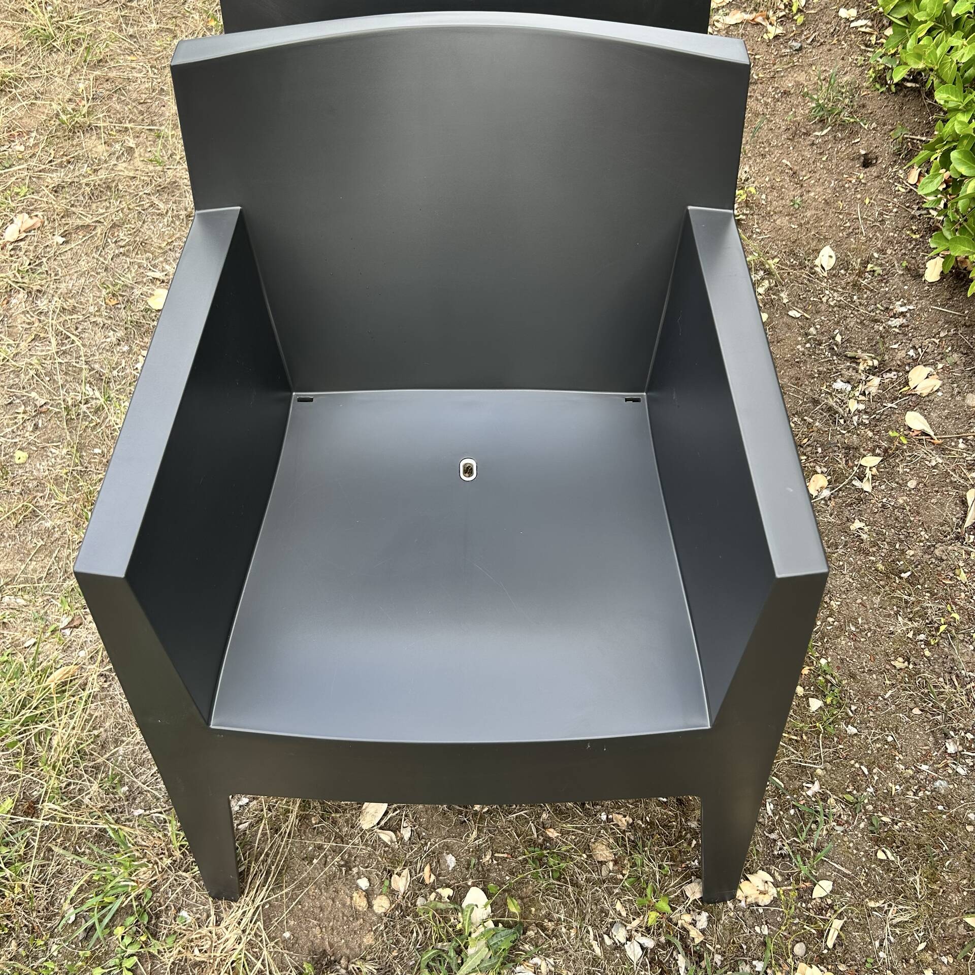 2 black Toy chairs designed by Starck