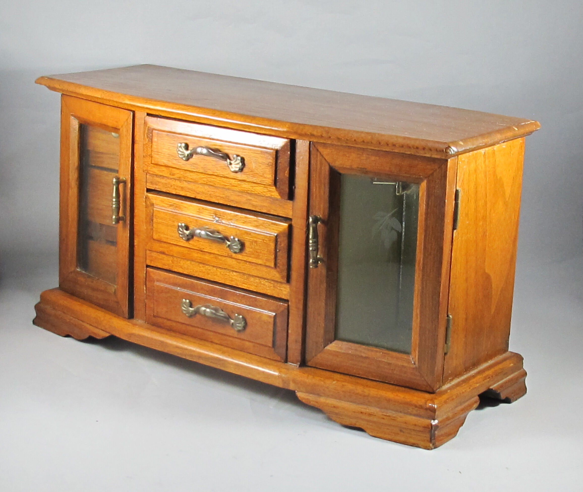 Wooden jewelry box in the shape of a chest of drawers