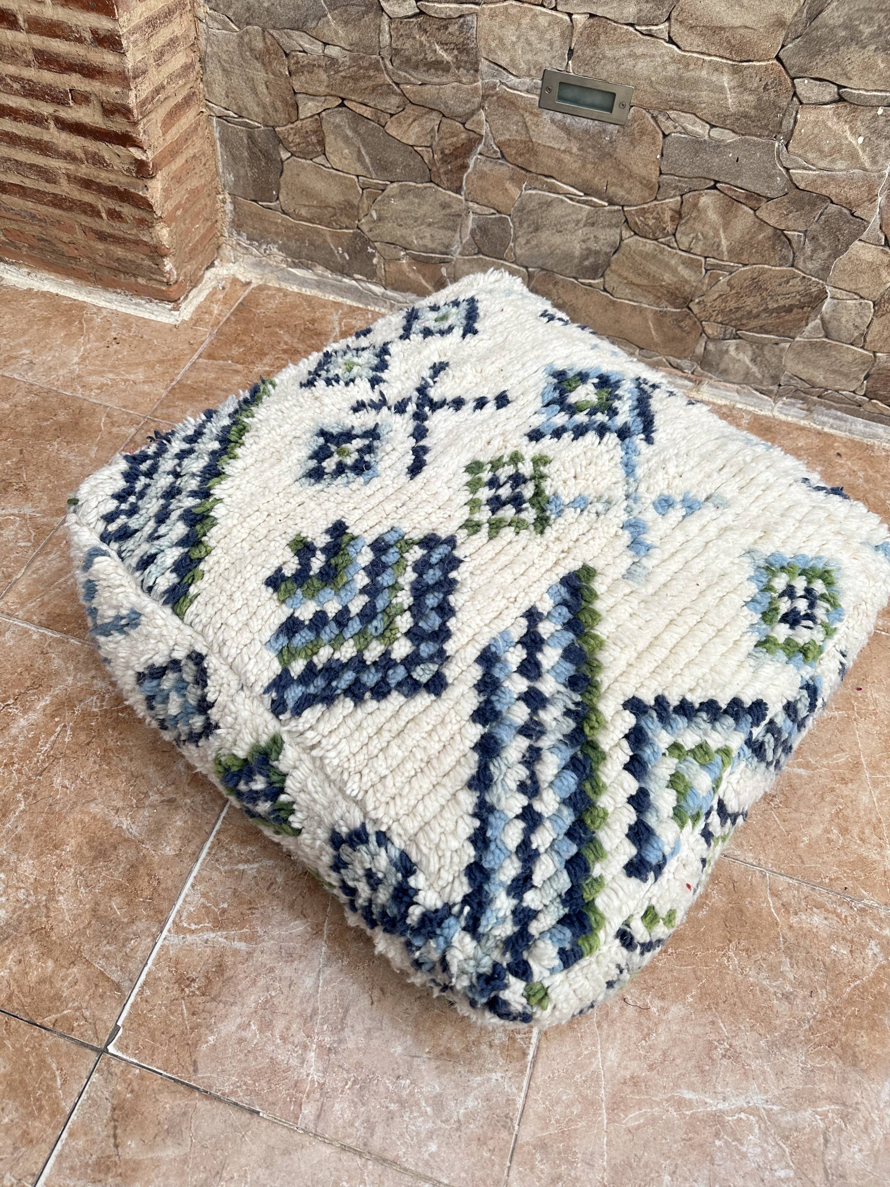 Berber floor pouf: Handwoven Moroccan wool cushion.