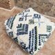 Berber floor pouf: Handwoven Moroccan wool cushion.