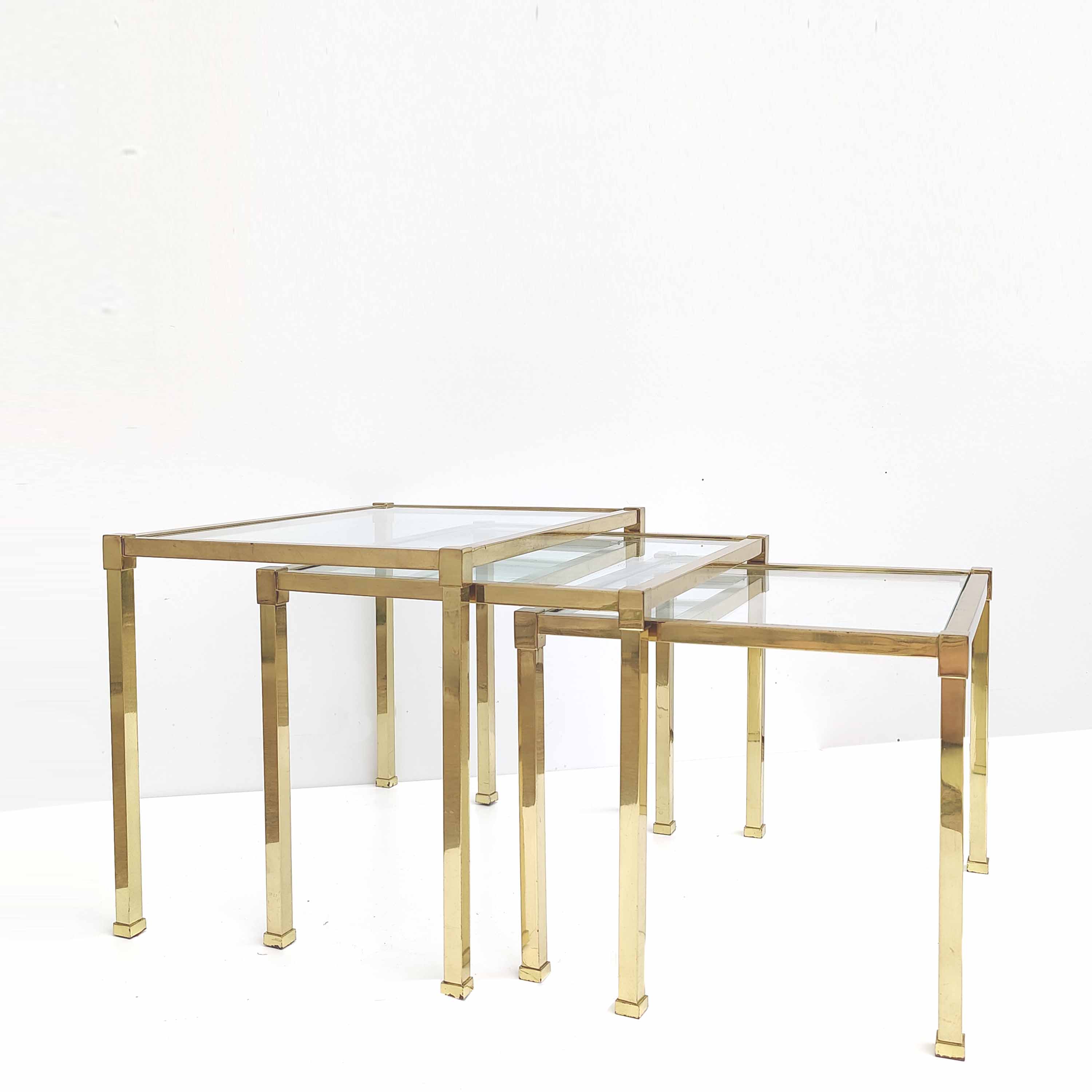 Brass and glass trundle tables