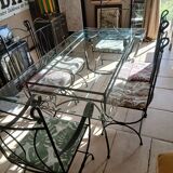 Glass table and wrought iron chairs