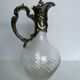 Glass decanter and silver metal frame
