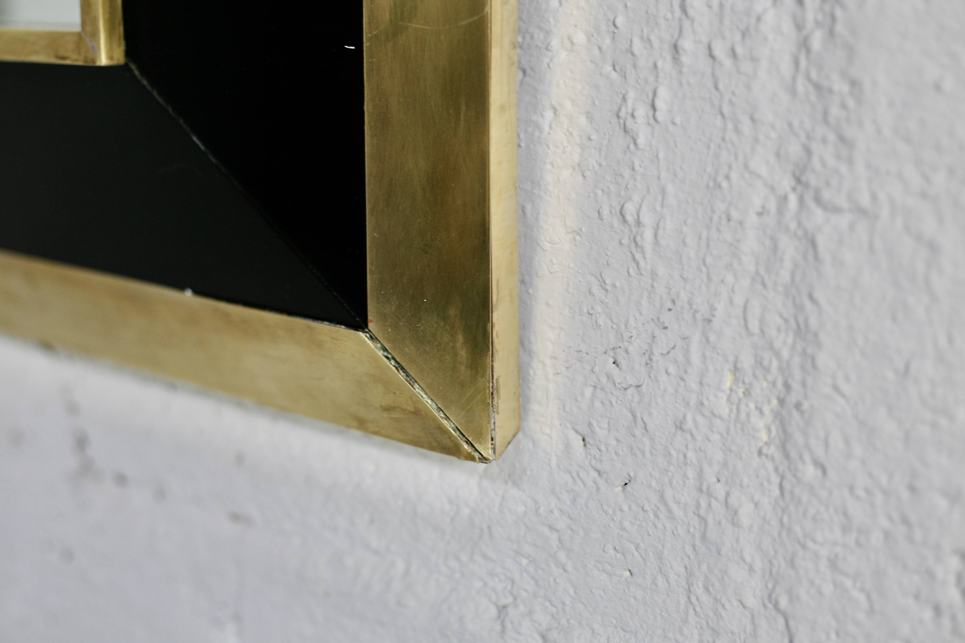 Jean-Claude Mahey mirror. Black lacquered wood and gold metal. 1970