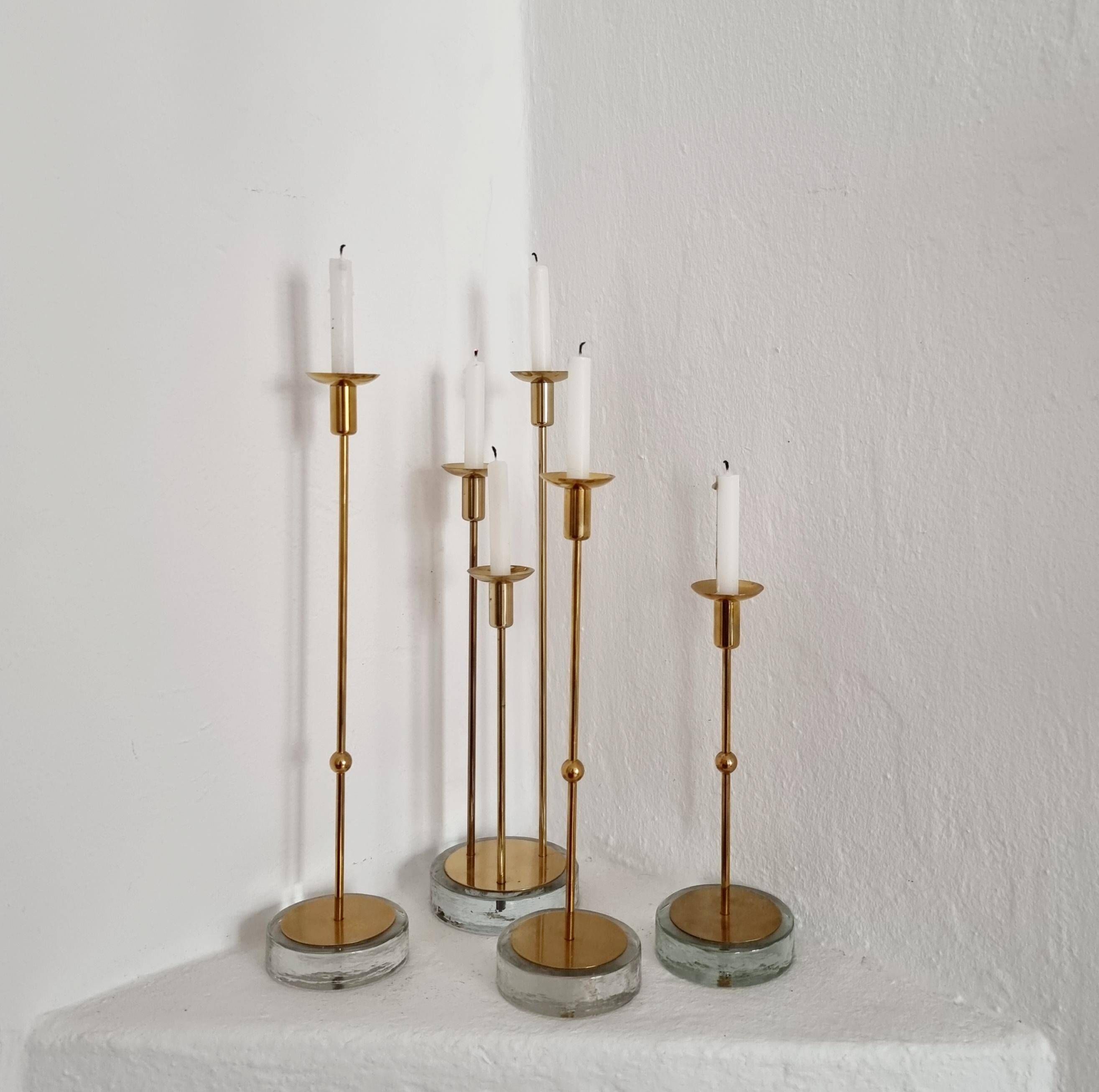 Gunnar Ander, four candlesticks, brass and glass, Ystad Metall, Swedish modern.