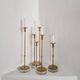 Gunnar Ander, four candlesticks, brass and glass, Ystad Metall, Swedish modern.