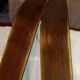 pair of vintage wooden Skis and their bats.
