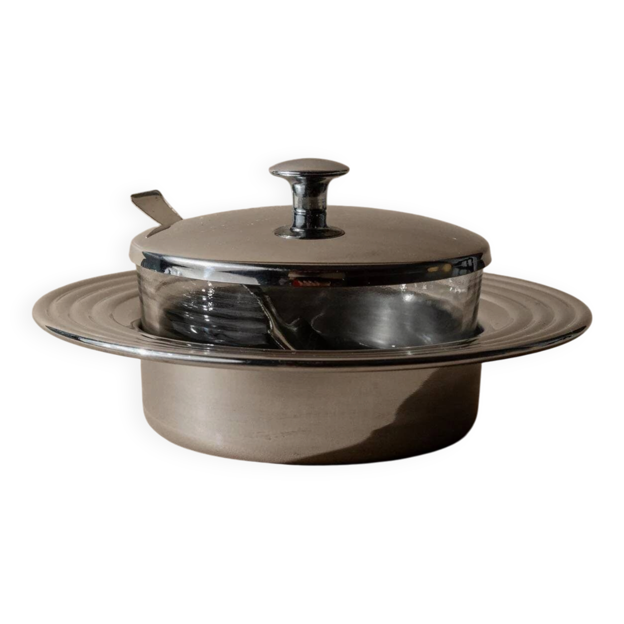 Vintage 1970s condiment pot made of glass and stainless steel with a lid, complete with a matching spoon.