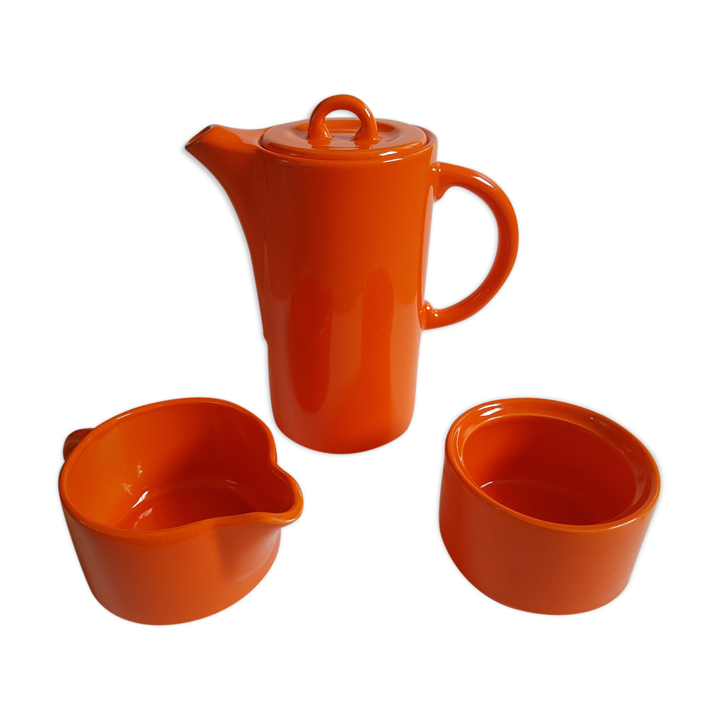 Coffee pot has orange 1970 sugar milk