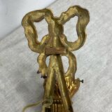 Bronze wall light, decorated with a bow and ribbon.