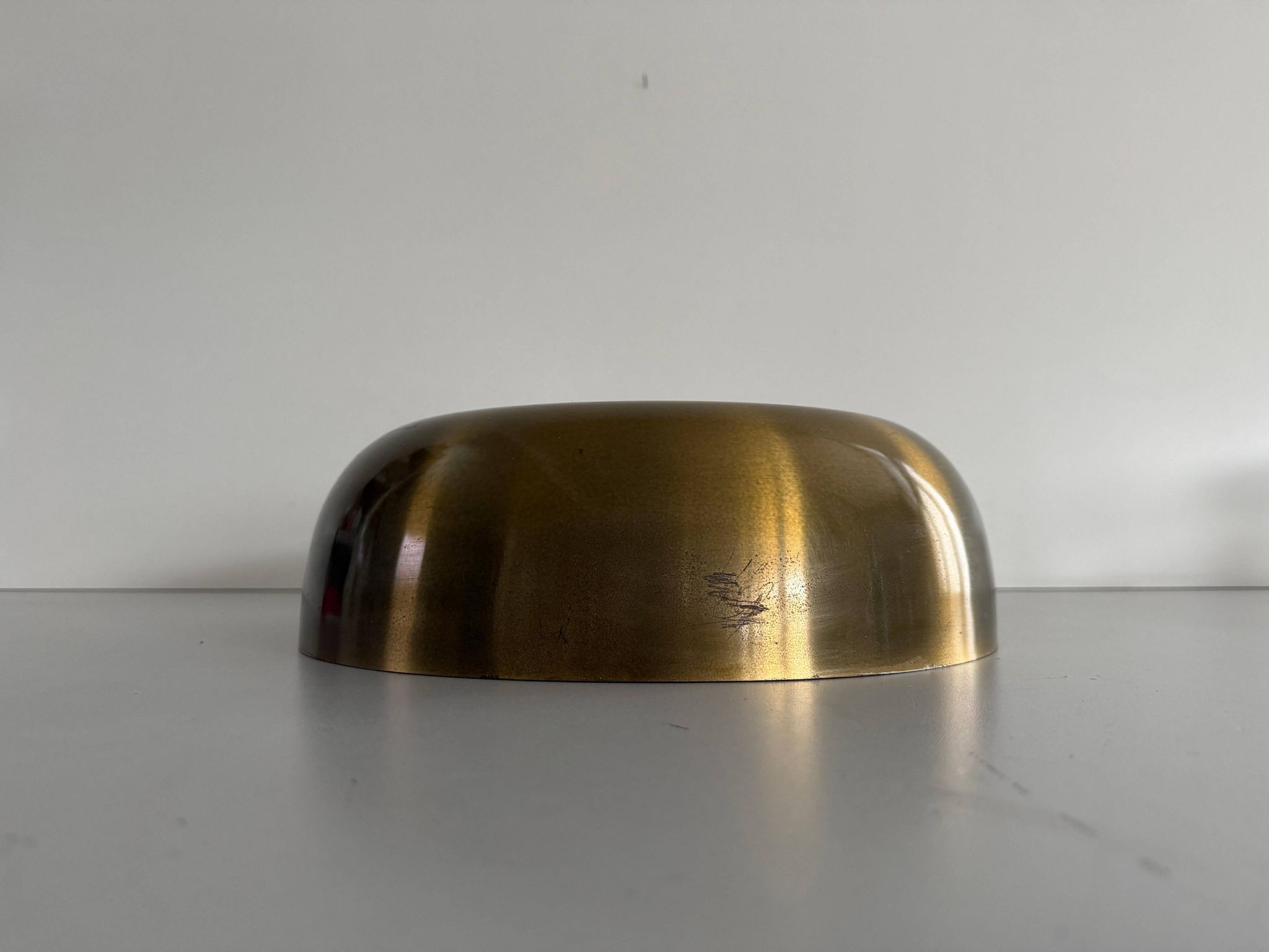 Flush-mounted disc-shaped brass fixture from the mid-century, 1960, Italy.
