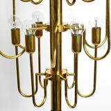 Three staged 18 arm Mid Century brass chandelier with a long brass rod