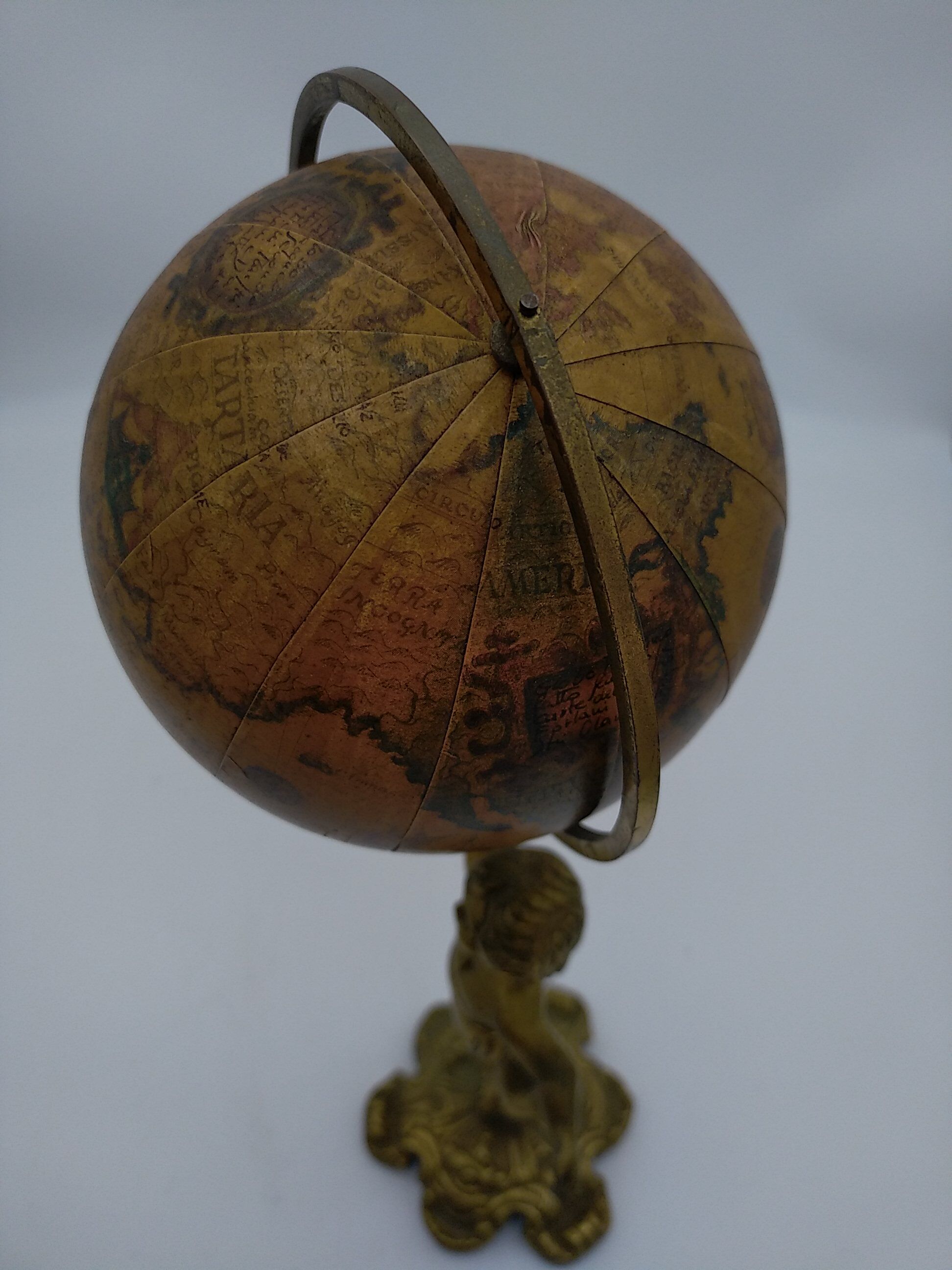 Cherub or putti carrying a globe