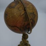 Cherub or putti carrying a globe