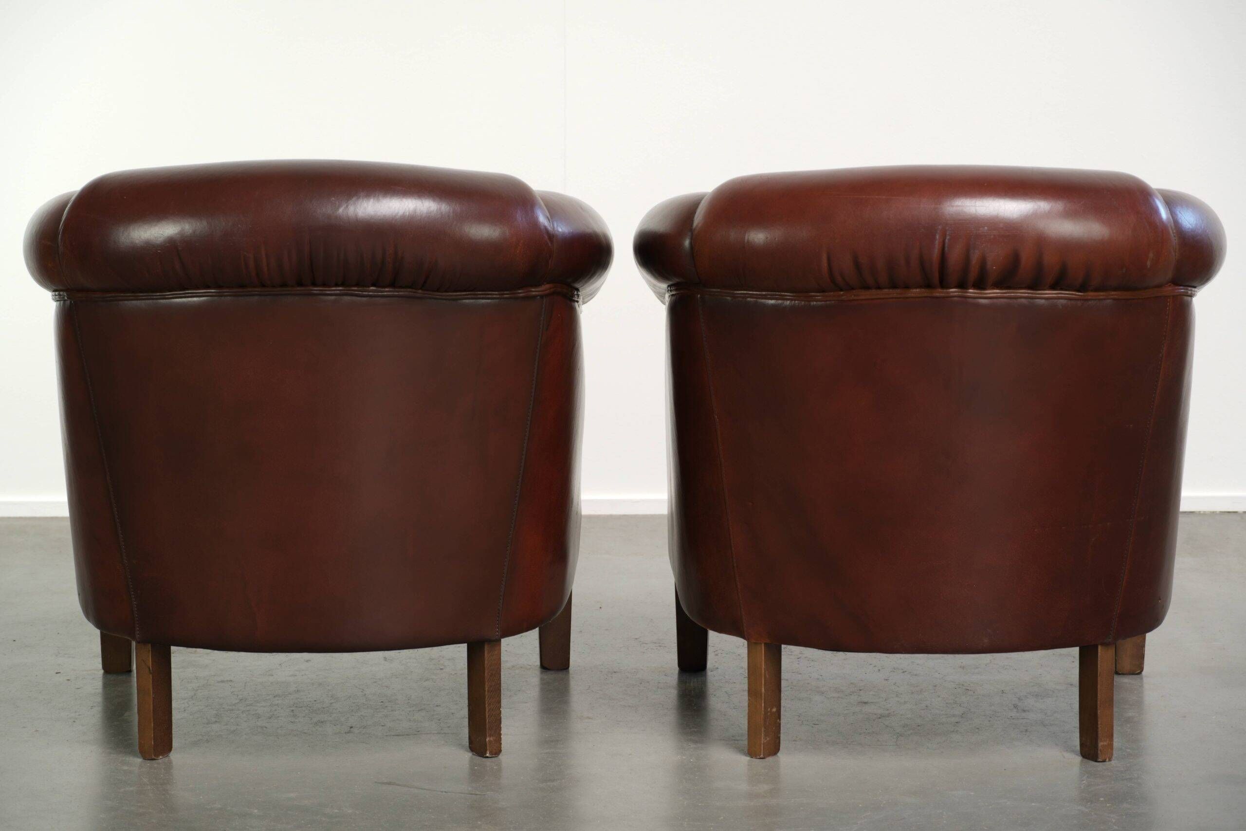 Set of 2 sheepskin club armchairs in a dark cognac colour