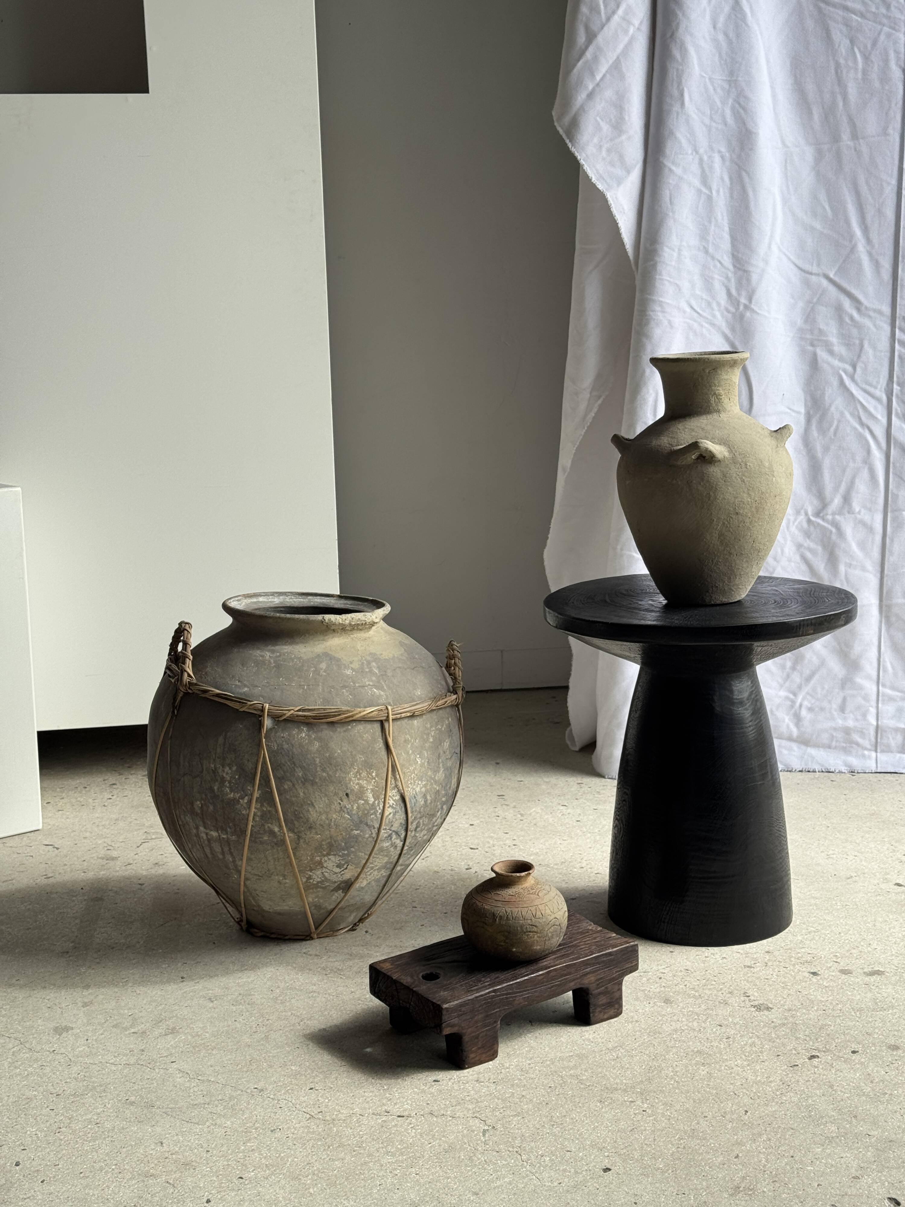 Black solid mango side table (monoxyle) with conical legs