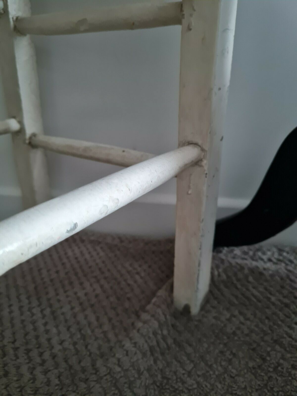 Vintage wooden stool with white peeling paint