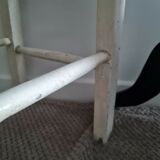 Vintage wooden stool with white peeling paint
